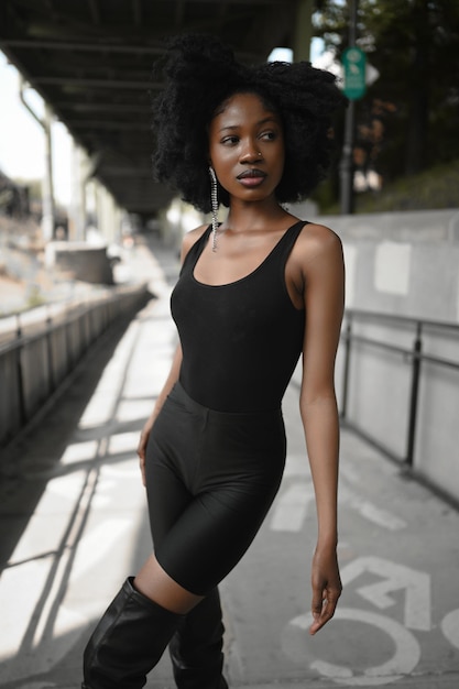 Fashion outdoor street style portrait beautiful young african american woman posing outside on urban