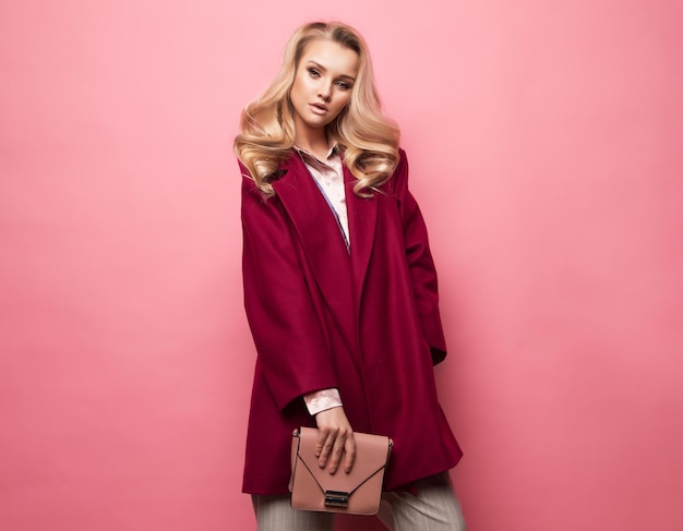 Fashion people and lifestyle concept Beautiful woman long blond curly hair wear cashmere coat and holding handbag