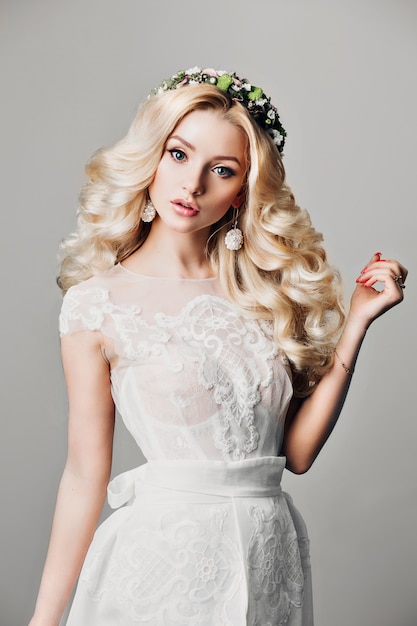 Fashion photo of young bride girl with long curly hair