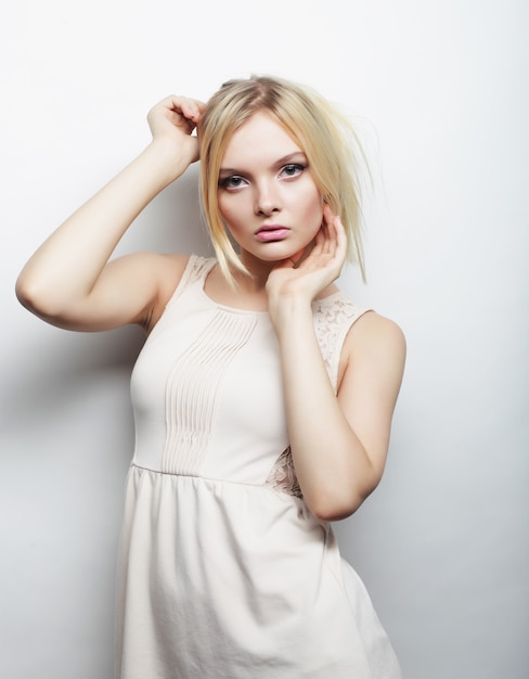 Fashion photo of young magnificent woman in white dress