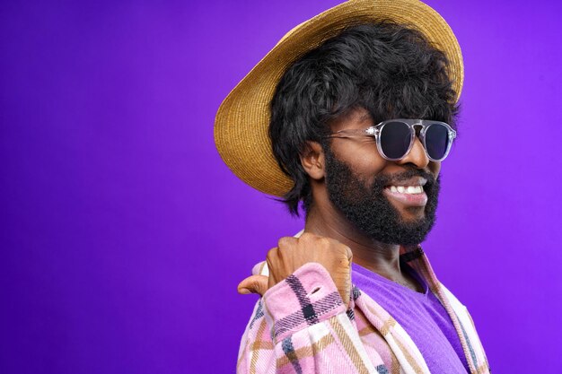 Fashion portrait of african american man in glasses against purple background