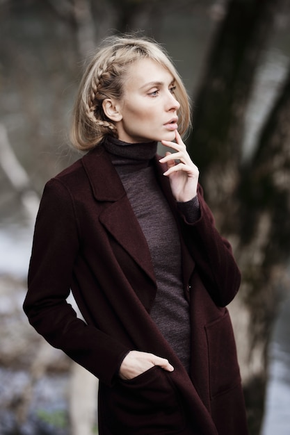 Fashion portrait of beautiful blonde woman in stylish clothes outdoor in autumn.