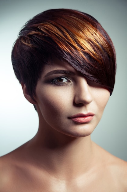 Fashion portrait of a beautiful girl with colored dyed hair, professional short hair coloring. studio shot.