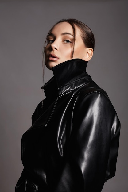 Fashion portrait of Beautiful woman in leather trench coat