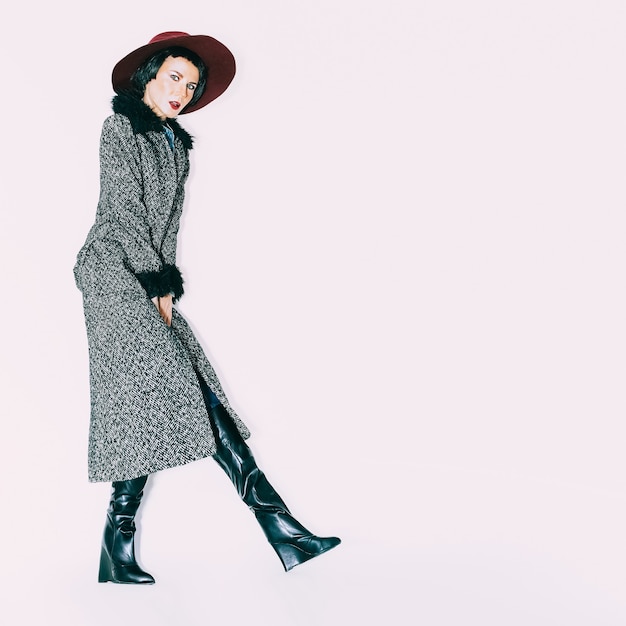 Fashion portrait glamorous model in a vintage hat and coat