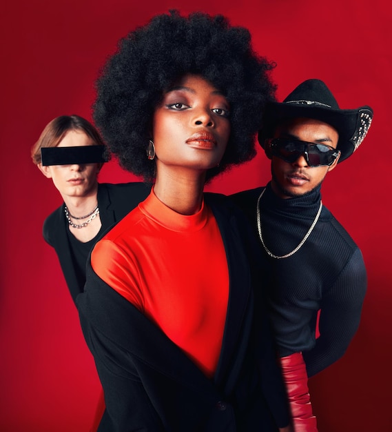 fashion portrait and a group of people style and retro clothes on a red studio background for art punk and creative aesthetic friends rock or a black woman with men with vintage or trendy outfit