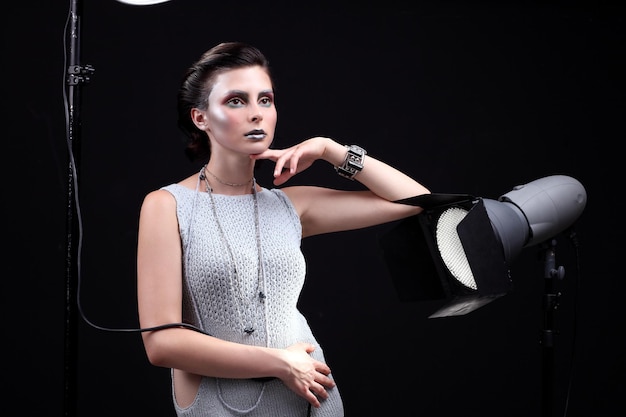 Fashion portrait of model in the light colored spotlights