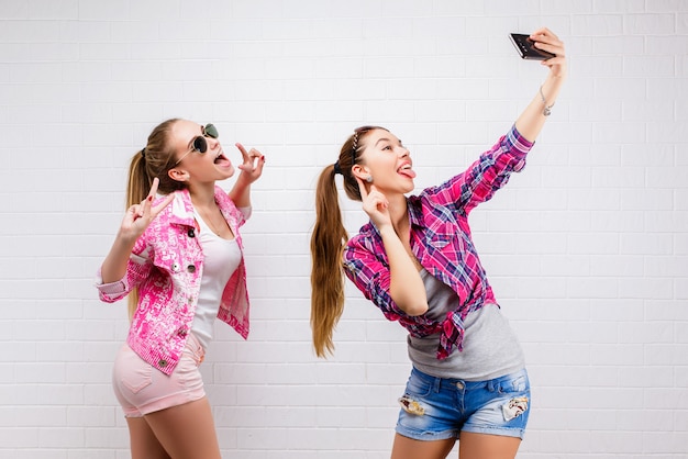 Fashion portrait of two friends posing. modern lifestyle