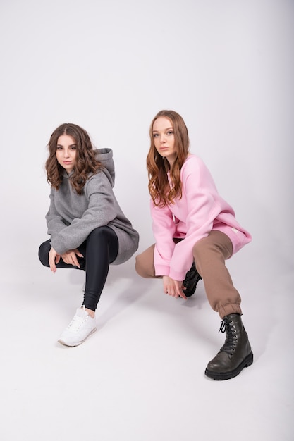 Fashion portrait of two girls, best friends posing indoor