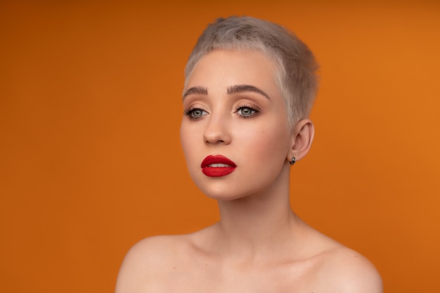 Fashion portrait woman with short hair red lips and naked shoulders