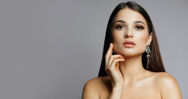 Fashion portrait of wonderful woman with shiny hair and evening makeup