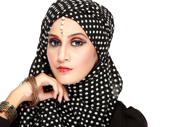 Fashion portrait of young beautiful muslim woman with black scarf