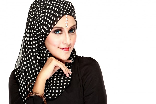 Fashion portrait of young beautiful muslim woman with black scarf