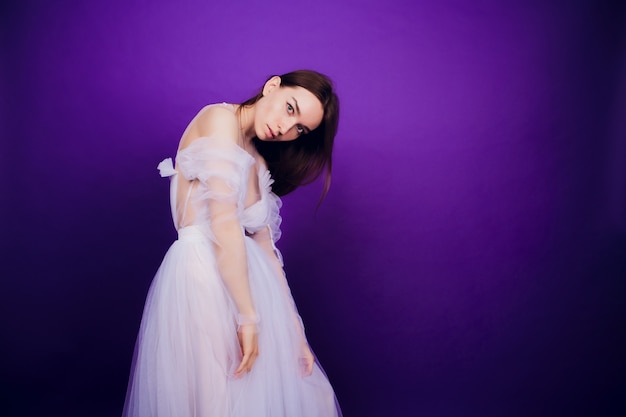 Fashion portrait young elegant girl in white dress.  Beautiful woman with red and blue. girl in neon.