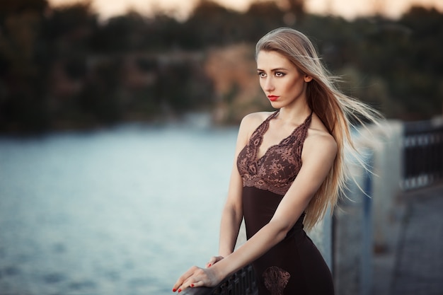 Fashion portrait of young model woman on urban background