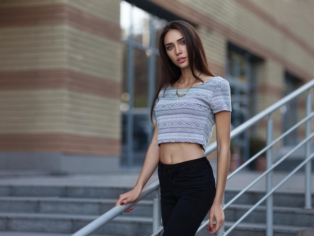 Fashion portrait of young model woman on urban background