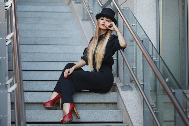 Fashion portrait of young model woman on urban background