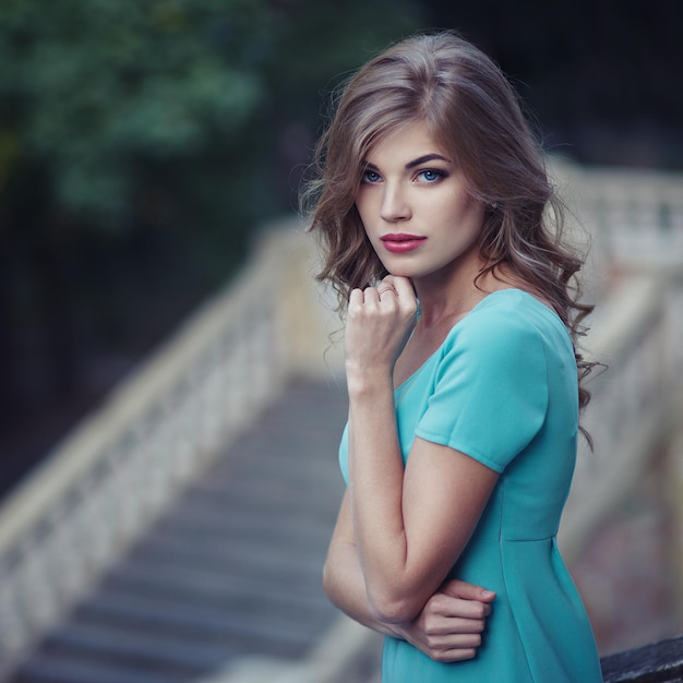 Fashion portrait of young model woman on urban background