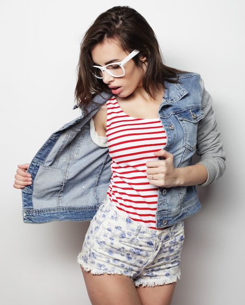 Fashion portrait of young pretty hipster woman over white background
