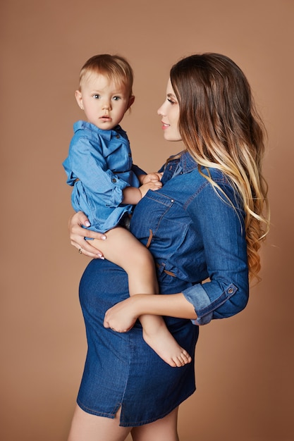 Fashion pregnant woman blonde with little child