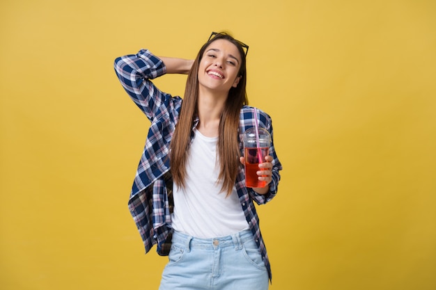 Photo fashion pretty young woman with fresh fruit juice cup in blue shirt having fun