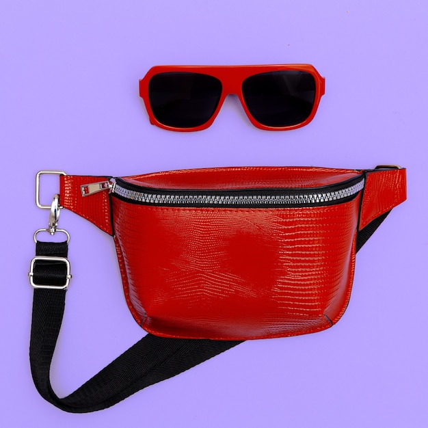 Fashion red clutch and sunglasses. Flat lay style