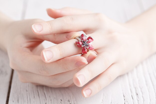 Fashion ring in female hands, close up