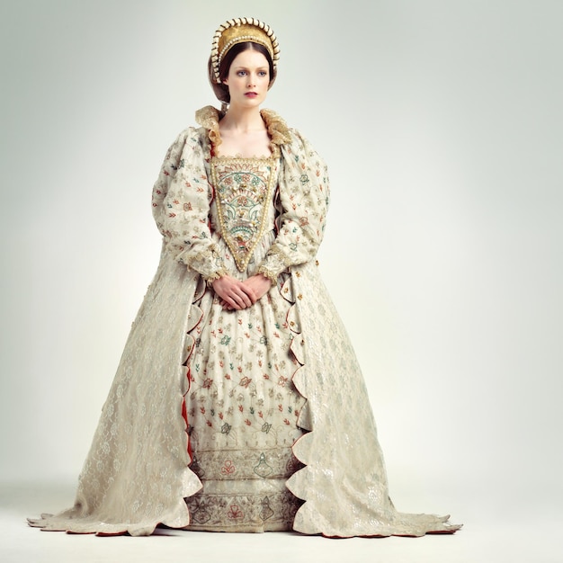 Fashion royal and victorian queen in studio with a renaissance luxury and fancy dress Royalty beauty and medieval woman ruler with elegant vintage and regal costume isolated by white background