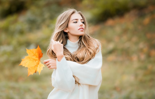 Fashion sensual woman walking in autumn park