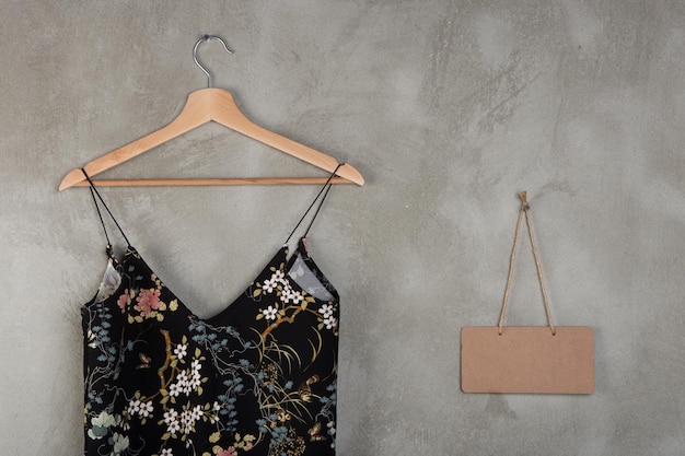 Photo fashion and shopping concept blank blackboard and beautiful little black dress on a hanger