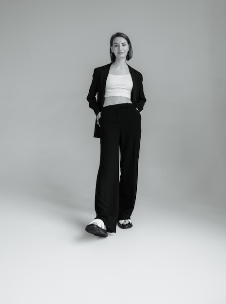 Fashion shot of stylish vogue woman in black suit in studio