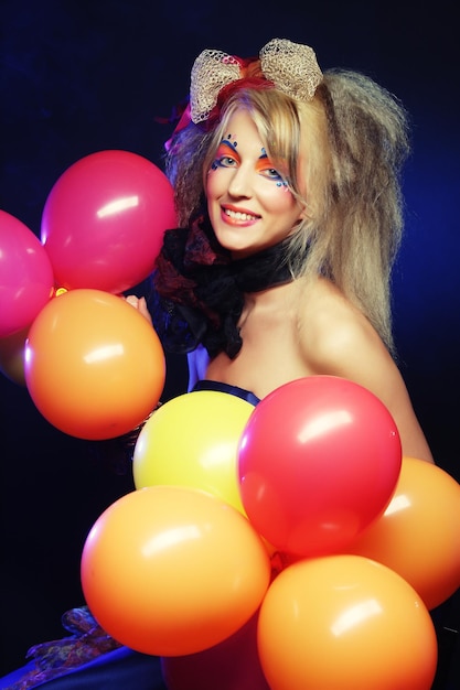 Fashion shot of woman in doll style with balloons