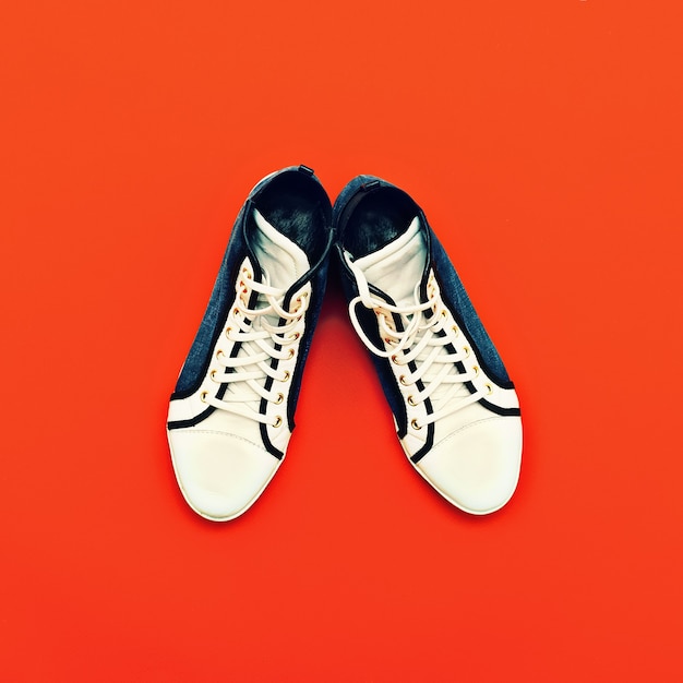 Fashion sneakers on bright red background