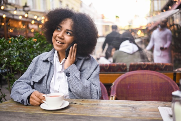 Fashion street style portrait of attractive young natural beauty african american woman with afro