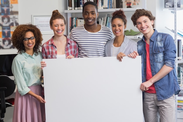 Fashion students smiling at camera together