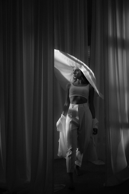 Fashion studio photo of elegant lady in giant white hat Health and beauty