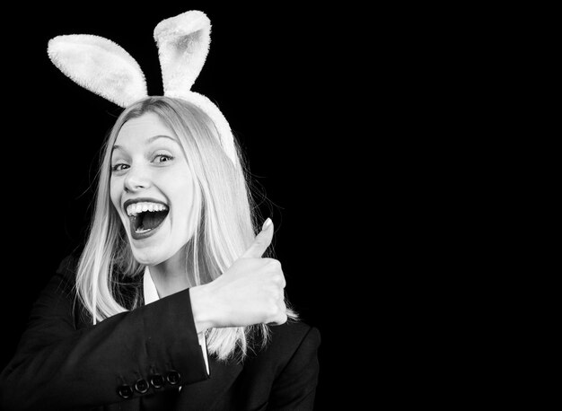 Fashion studio photo of sexy beautiful girl with blond hair with bunny ears hunting eggs rabbit woma...