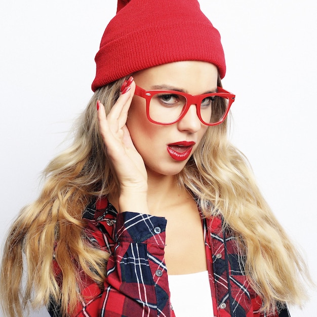 Fashion studio portrait of pretty young hipster blonde woman with bright sexy make up and glasses