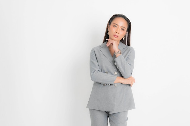 Fashion style catalog clothing for business woman black long hair natural make up wear gray suit costume perfect body shape suit at studio shoot on white background and shadow.