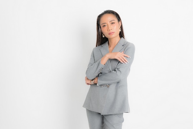 Fashion style catalog clothing for business woman black long hair natural make up wear gray suit costume perfect body shape suit at studio shoot on white background and shadow.