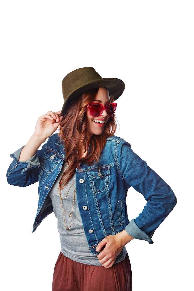 Photo fashion style and woman in a studio with a casual stylish and funky outfit with accessories happiness smile and female model with hat sunglasses and edgy clothes isolated by a white background