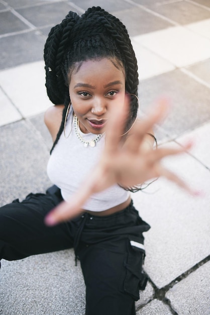 Fashion stylish and black woman in the city street with urban designer clothes from above Face portrait of a young trendy and cool African girl model with style vision and creativity in the road