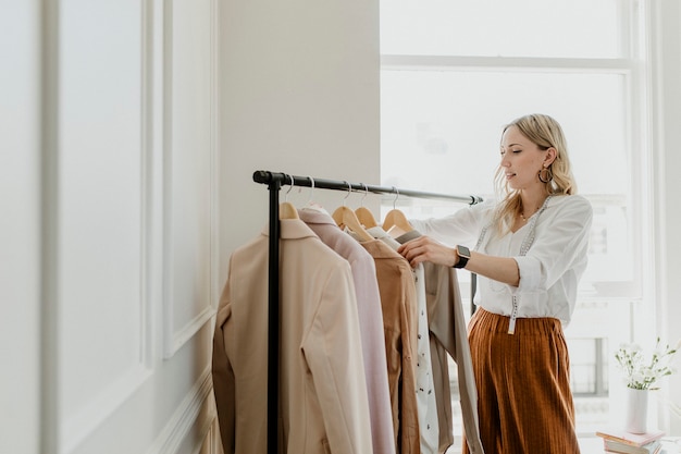 Fashion stylist sorting the clothing rack