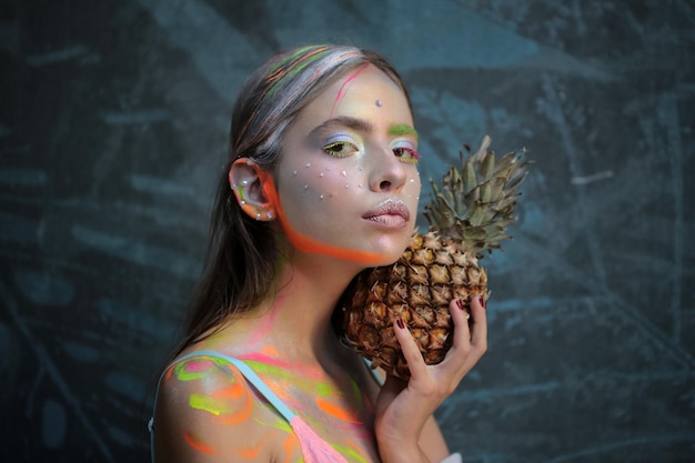 Fashion summer makeup. abstract summer makeup. pineapple fruit.\
fashion girl with colorful powder make up. colourful make-up.