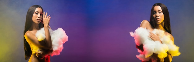 Moda donna asiatica transgender pelle abbronzata lunghi capelli neri bellissimi accessori per il trucco di alta moda, con una grande nuvola bianca. studio illuminazione blu viola fumo sfondo spazio copia logo testo