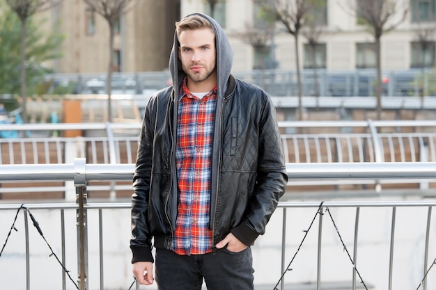 Fashion for urban lifestyle. Handsome guy wear hooded fashion jacket. Young man in autumn style outdoors. Fashion wardrobe for fall. Mens fashion trends and seasonal style.