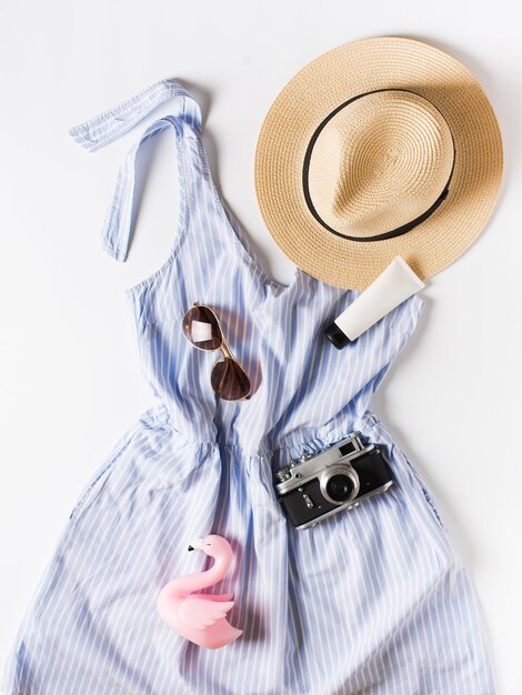 Fashion vacation flat lay with blue summer dress hat sunglasses and other accessories