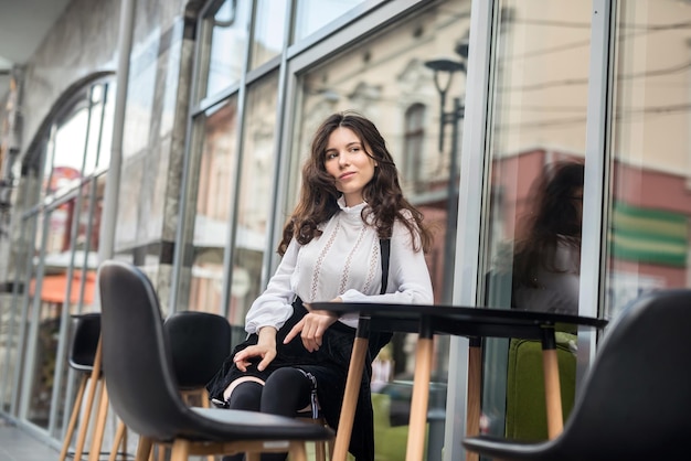 Fashion woman posing near cafe summer time