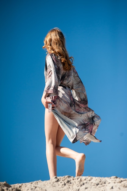 Fashion woman posing in sunny summer day