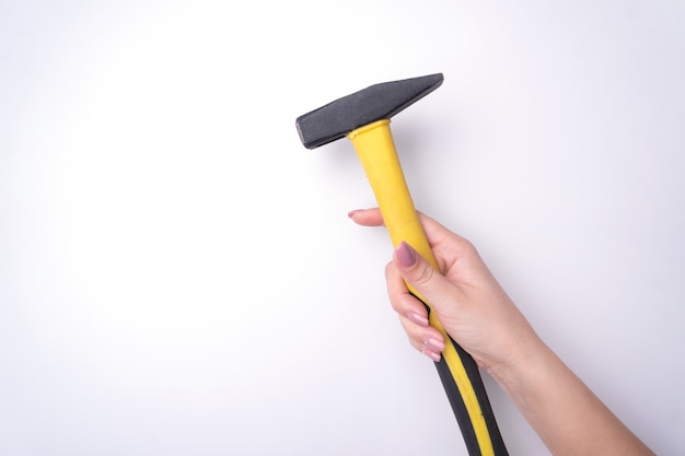 Fashion woman's hand with a gentle manicure holds a tool. 